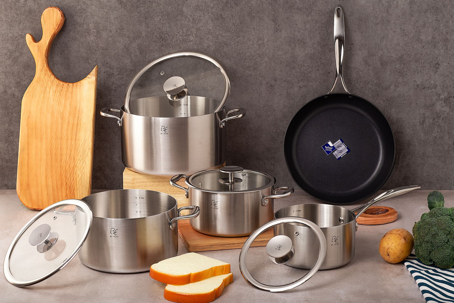 Premium polished stainless steel cookware set in a clean modern kitchen setting